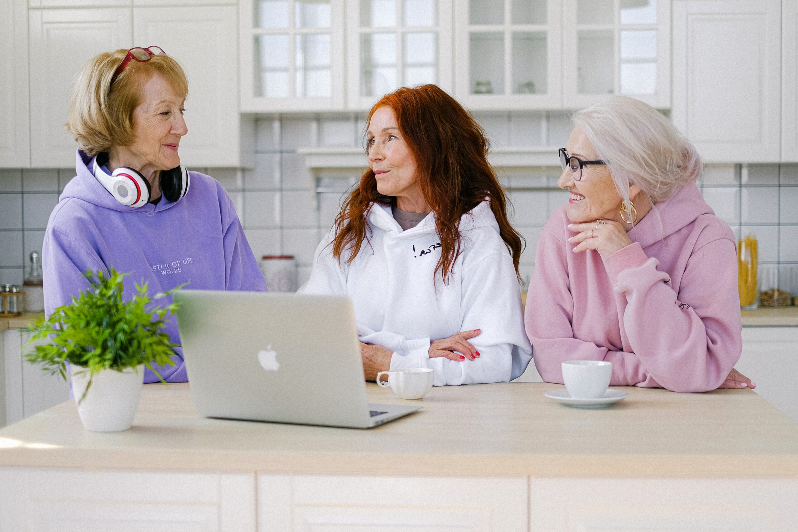 three-women-using-a-laptop-in-the-kitchen