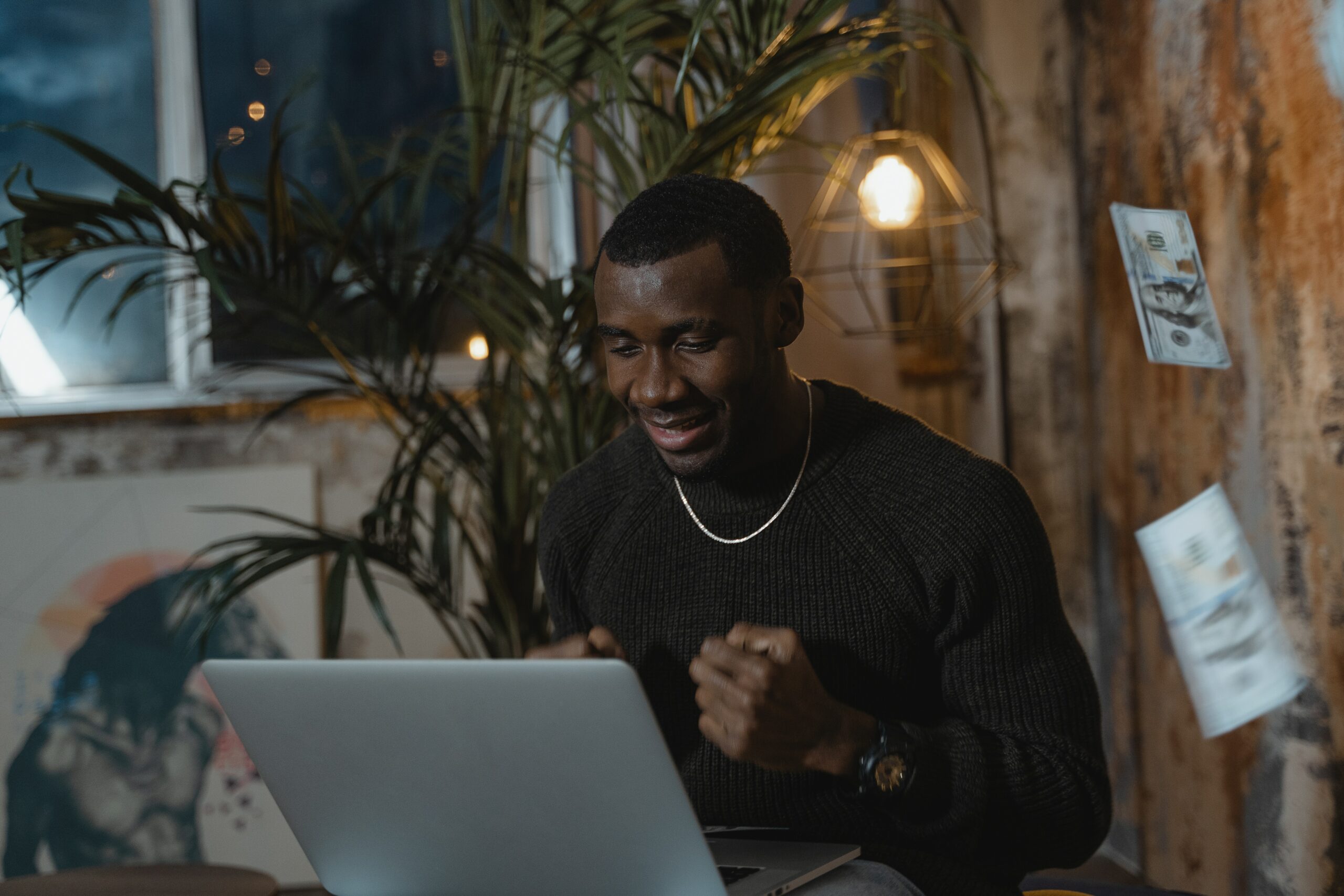 man-triumphantly-faces-the-laptop